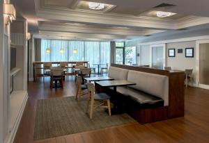 a restaurant with a couch and tables and chairs at Hampton Inn Middletown in Middletown