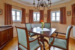 a dining room with a wooden table and chairs at Kurhaus Dr. Petershofer in Wolfsegg am Hausruck