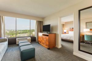 a hotel room with a bed and a television at Hampton Inn Manassas in Manassas