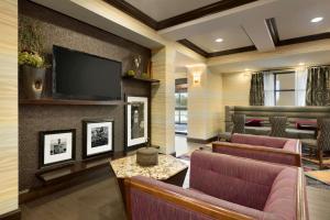 a living room with couches and a flat screen tv at Hampton Inn West Monroe in West Monroe