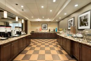 a large kitchen with a checkerboard floor at Hampton Inn West Monroe in West Monroe