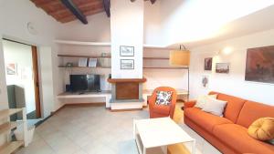 a living room with a couch and a tv at RomagnaBNB Casa Laura in Forlì