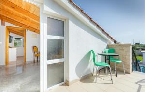 a patio with chairs and a table on a balcony at Beautiful Home In Pomer in Pomer +28 photos