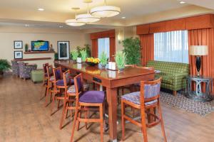 a dining room with a large wooden table and chairs at Hampton Inn Macomb in Macomb