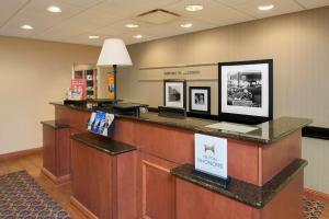 a lobby with a reception desk in a hospital at Hampton Inn Macomb in Macomb