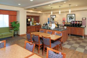 a dining room with a table and chairs at Hampton Inn Macomb in Macomb