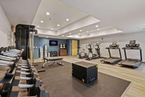 a gym with several tread machines and a tv in it at Hampton Inn & Suites Modesto - Salida in Modesto