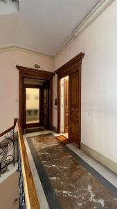 an empty room with two doors and a staircase at Sea Glimpse Studio - Santa Lucia in Naples