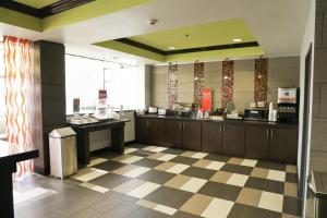 a large kitchen with a counter in a restaurant at Hampton Inn Muskogee in Muskogee