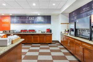 a fast food restaurant with a kitchen with a counter at Hampton Inn & Suites Minneapolis St. Paul Airport - Mall of America in Bloomington