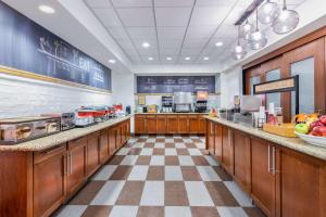 a large kitchen with wooden cabinets and a checkered floor at Hampton Inn & Suites Minneapolis St. Paul Airport - Mall of America in Bloomington