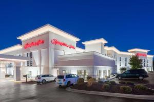 a building with cars parked in a parking lot at Hampton Inn Mount Airy in Mount Airy