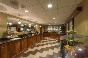 a large kitchen with wooden cabinets and a checkered floor at Hampton Inn Mount Airy in Mount Airy