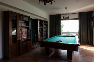 a living room with a pool table and a window at Villa Il Torchio in Messina