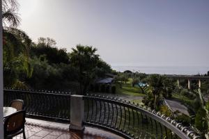 a balcony with a fence and a view of a park at Villa Il Torchio in Messina