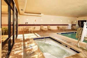 a swimming pool with a table and chairs in a building at Hampton Inn Montrose in Montrose