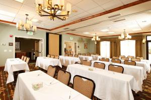 uma sala de banquetes com mesas e cadeiras brancas em Hampton Inn Montrose em Montrose