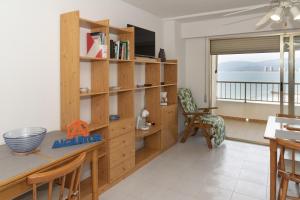a room with a desk and book shelves and a table at Orly, A-6-38 PK 125 in Cullera