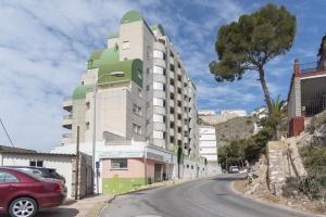 a building on the side of a street at Orly, A-6-38 PK 125 in Cullera