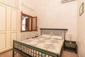 a bedroom with a bed and a window at trilocale con piscina in Arzachena