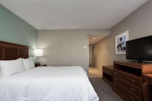 a hotel room with a bed and a flat screen tv at Hampton Inn Harbourgate in Myrtle Beach