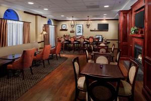 a restaurant with tables and chairs in a room at Hampton Inn Newberry Opera House in Newberry