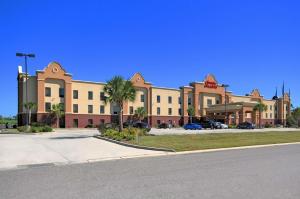 a large building with a parking lot in front of it at Hampton Inn and Suites New Iberia in New Iberia