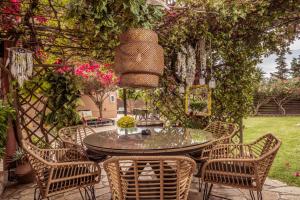 a patio with a table and chairs in a yard at Filoxenia Luxury Studios & Apartments in Zakynthos Town