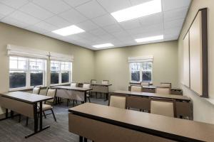 a classroom with tables and chairs and windows at Homewood Suites by Hilton Newark Fremont in Fremont