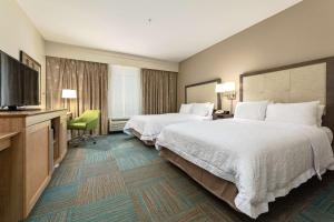 a hotel room with two beds and a flat screen tv at Hampton Inn Niceville-Elgin Air Force Base in Niceville +15 photos
