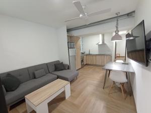 a living room with a couch and a table at Apartamento full equip. in Bilbao