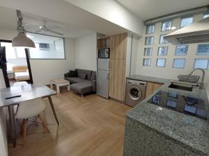 a kitchen and a living room with a table at Apartamento full equip. in Bilbao