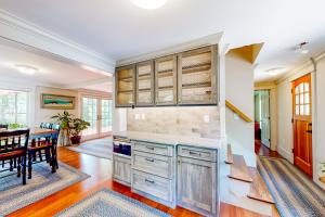 a kitchen with a table and a dining room at Overland Glen in Mashpee
