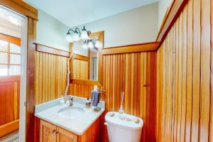 a bathroom with a sink and a toilet at Overland Glen in Mashpee +30 photos