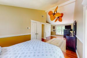 a bedroom with a bed and a ceiling fan at Overland Glen in Mashpee
