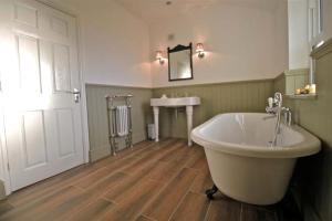 a large bathroom with a tub and a sink at Birches Brow Boutique Guest Rooms in Aughton
