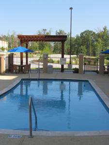 a large swimming pool with a gazebo and anophe at Hampton Inn & Suites Center in Center