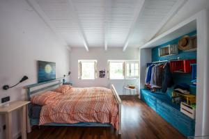 a bedroom with a bed and blue walls at Casa Tommasini in Capaccio-Paestum