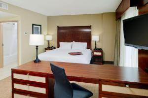 a hotel room with a bed and a desk with a computer at Hampton Inn & Suites Ocean City in Ocean City