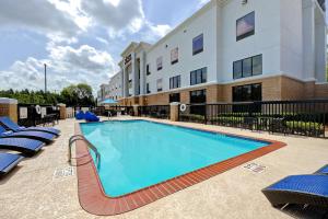 a swimming pool in front of a hotel at Hampton Inn & Suites Nacogdoches in Nacogdoches
