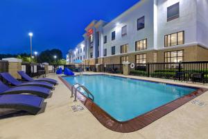 a pool in front of a hotel at night at Hampton Inn & Suites Nacogdoches in Nacogdoches