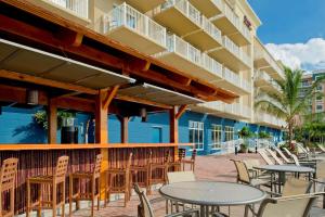 a patio with tables and chairs in front of a building at Hampton Inn & Suites Ocean City in Ocean City