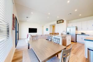 a kitchen and living room with a table and chairs at Desert Oasis in Prescott Valley