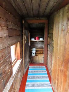 a small room with a toilet in a wooden house at Tenon maisemamökit in Utsjoki