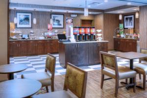 a restaurant with tables and chairs and a counter at Hampton Inn Crystal River in Crystal River