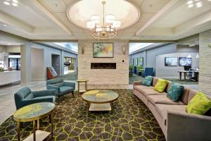 a lobby with a couch and chairs and a fireplace at Homewood Suites by Hilton Ocala at Heath Brook in Ocala