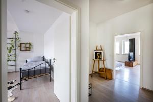 ein Schlafzimmer mit einem Bett und ein Zimmer mit einem Spiegel in der Unterkunft Altstadtjuwel mit Loft Charme - Netflix in Koblenz