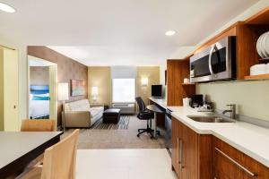 a hotel room with a kitchen and a living room at Home2 Suites By Hilton Omaha West in Omaha
