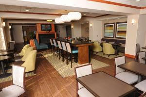a restaurant with tables and chairs and a dining room at Newly Renovated Hampton Inn Omaha West Lakeside in Omaha