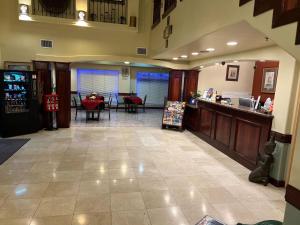 a lobby with a restaurant with a table and chairs at Casa Rosa Inn in Port Isabel